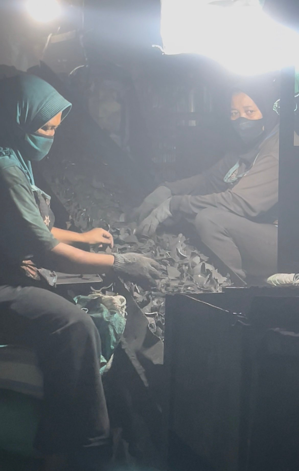 Workers hand-sorting selected coconut shell