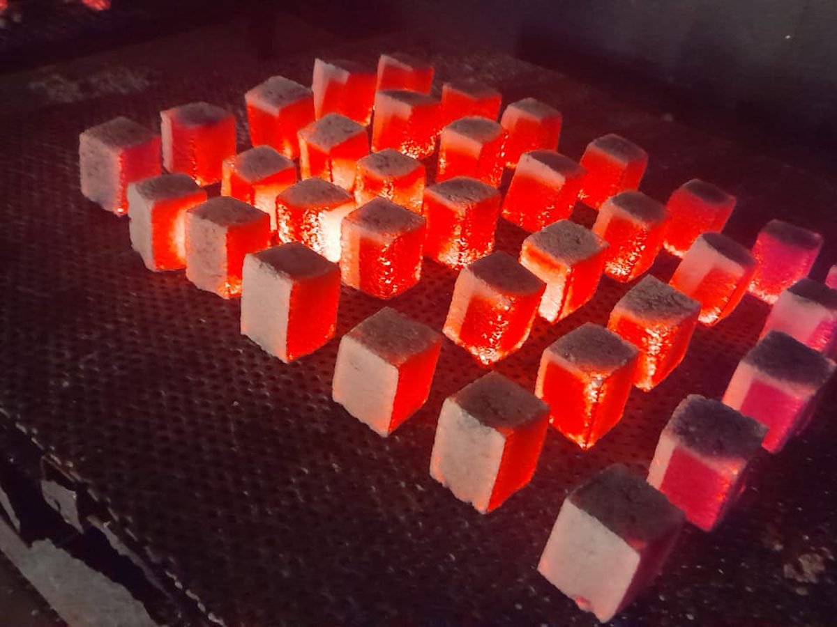 Glowing coconut shell charcoal cube briquettes